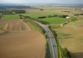 einige Straßen und Wege durchziehen eine Landschaft aus Feldern, vereinzelt gibt es Häuser